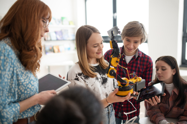 Young High school student is presenting her robotic project in a classroom