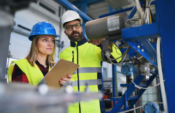 Female engineering manager and mechanic worker inside the factory