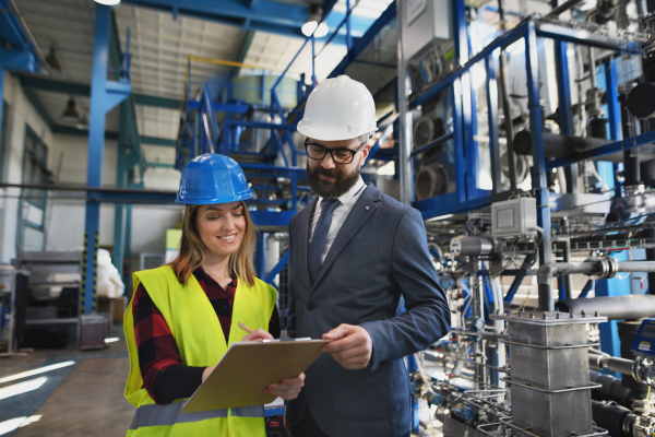 Female engineering manager and mechanic worker inside the factory