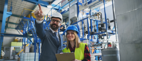 Female engineering manager and mechanic worker inside the factory