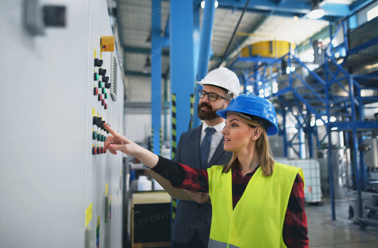 Female engineering manager and mechanic worker inside the factory