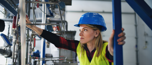 A portrait of female engineer working in industrial factory