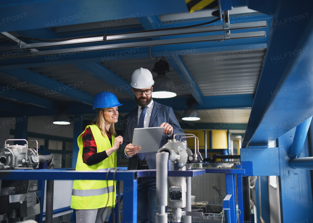 Female engineering manager and mechanic worker inside the factory