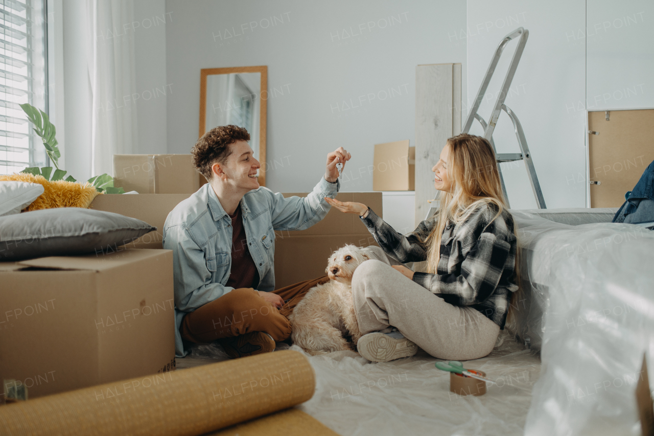 A cheerful young couple in their new apartment. Conception of moving.