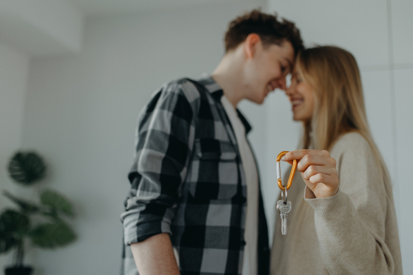 A cheerful young couple in their new apartment. Conception of moving.