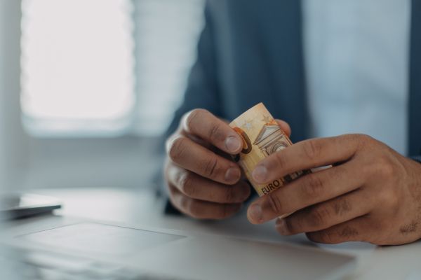 A close-up of businessman man holding euro money, inflation concept.