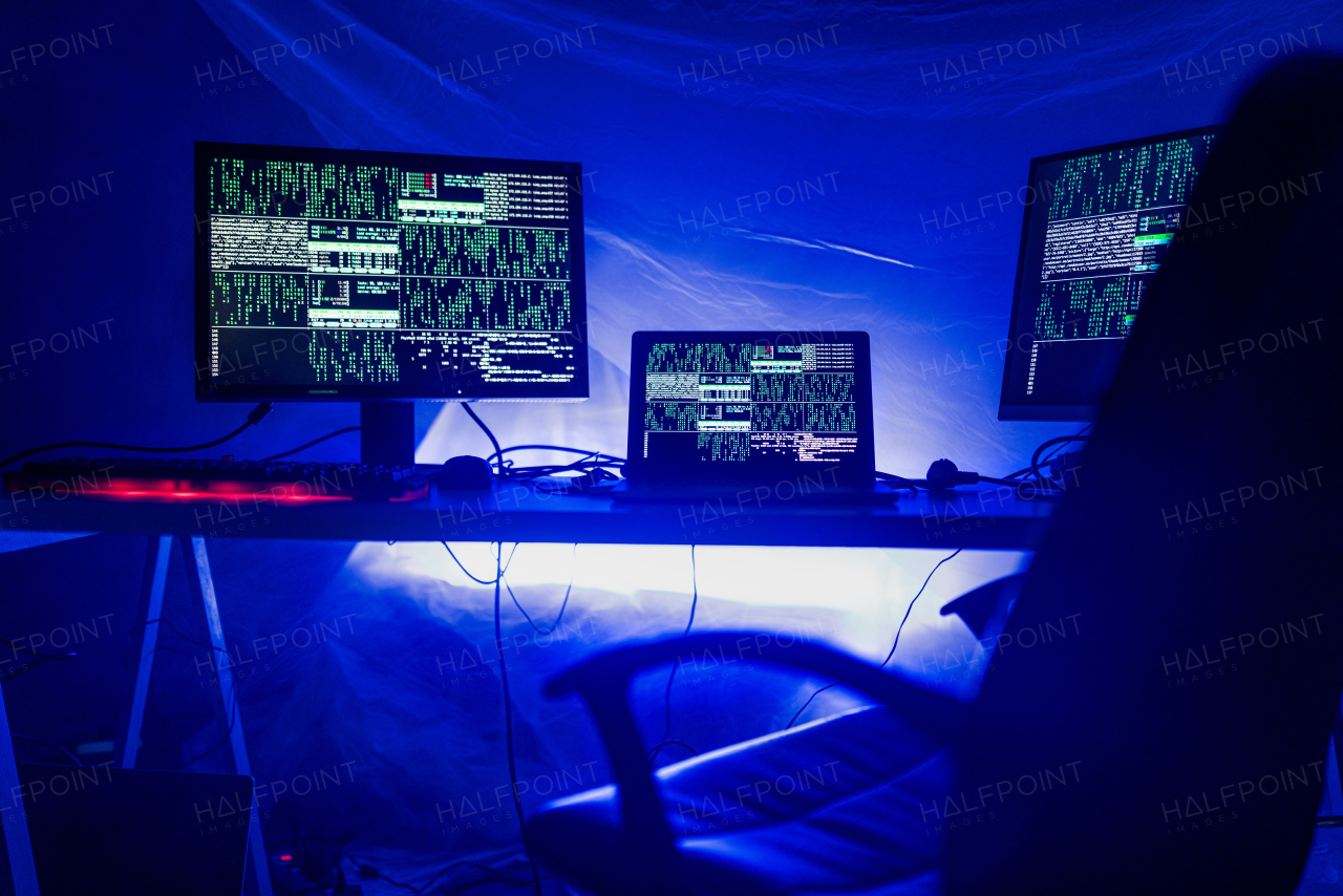 An internet hacker workplace in dark office, cyberwar concept.