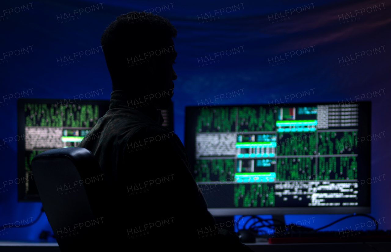 An American hacker in military unifrorm on dark web, cyberwar concept.