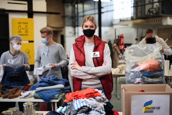 Volunteers collecting donations for the needs of the Ukrainian migrants, humanitarian aid concept.