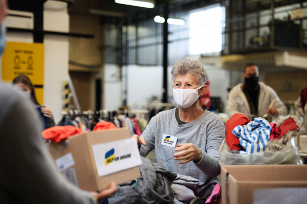 Volunteers collecting donations for the needs of the Ukrainian migrants, humanitarian aid concept.