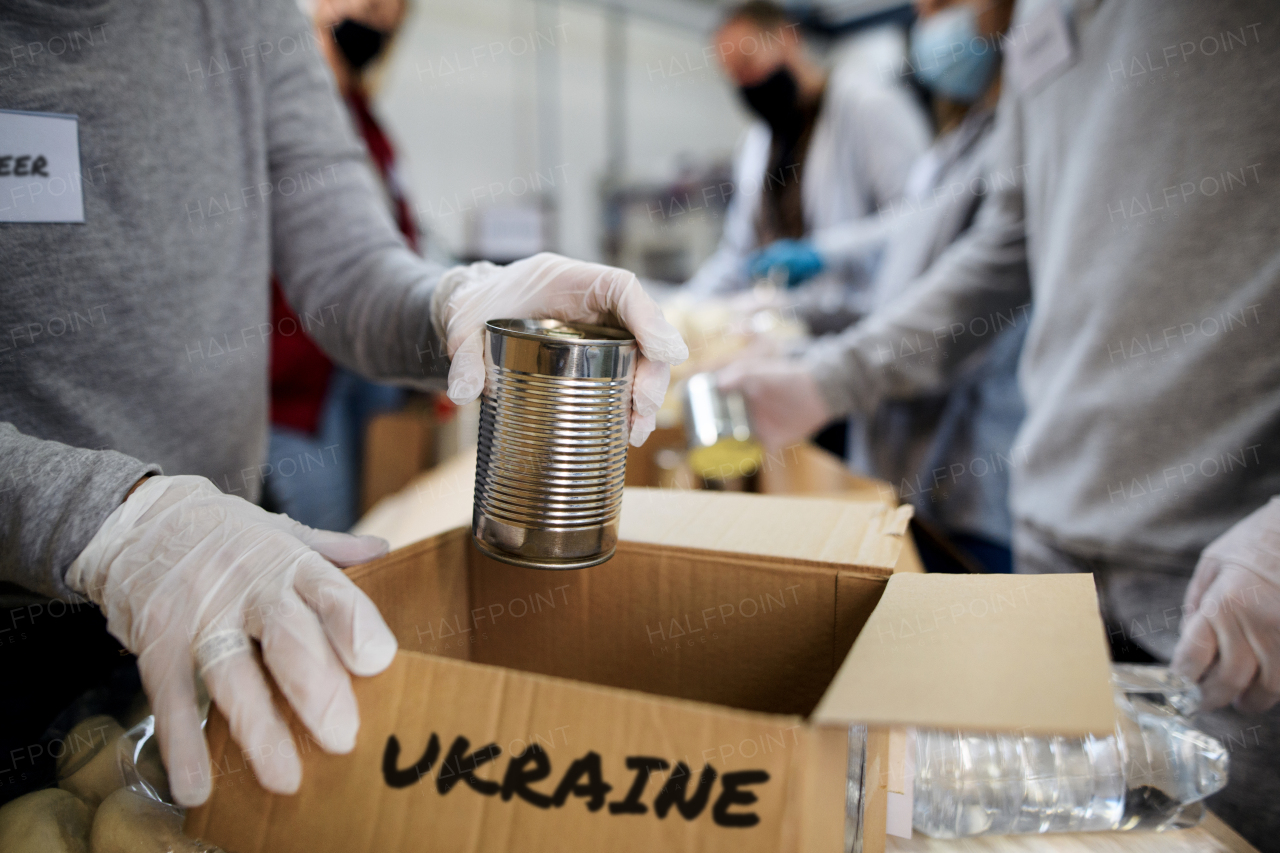 A group of volunteers collect donations for Ukrainian refugees, humanitarian aid concept.