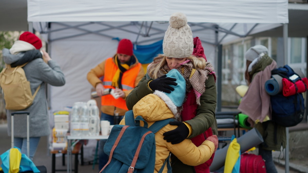 The Ukrainian refugee mother with child crossing border.