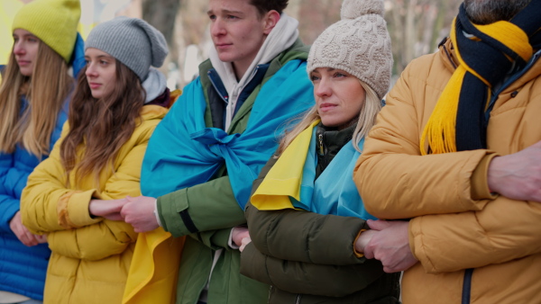 The protestors with Ukrainian blue and yellow flags protesting against war in Ukraine in street