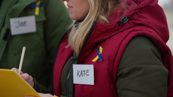 A close-up of volunteer distributing blankets and other donations to refugees on the Ukrainian border.