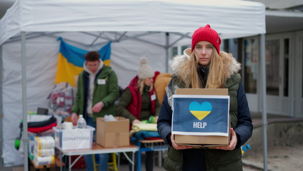 The volunteers distributing dontaions to refugees on the Ukrainian border, Russian-Ukrainian war concept.