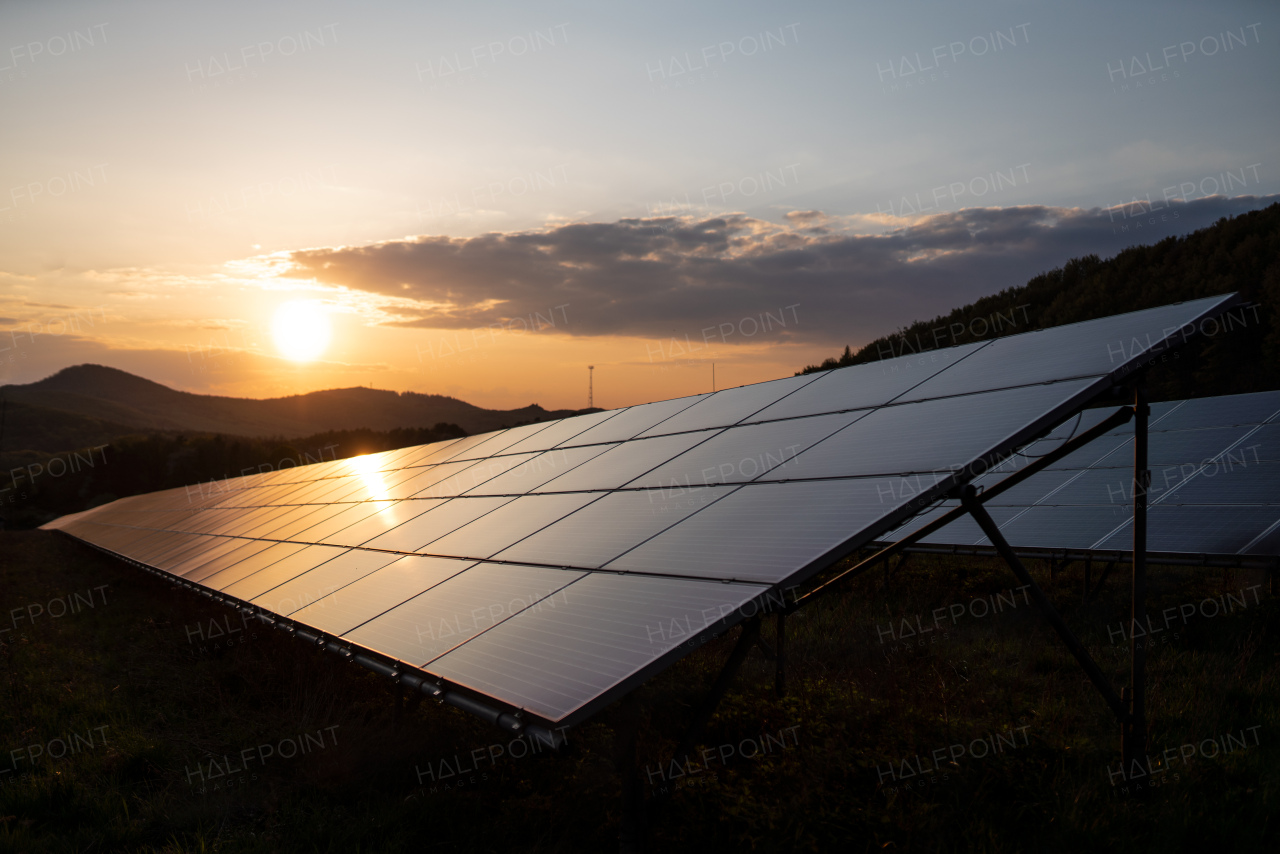 A solar panel against sunset background. Photovoltaic, alternative electricity source.