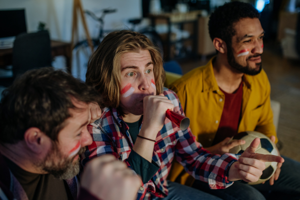 Happy Austrian football fans friends watching football at home and celebrating success