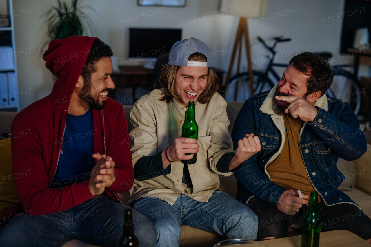 Happy football fans friends watching a football at home and talking