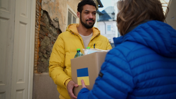 Volunteers collecting boxes with Humanitarian aid for the Ukrainian refugees in street