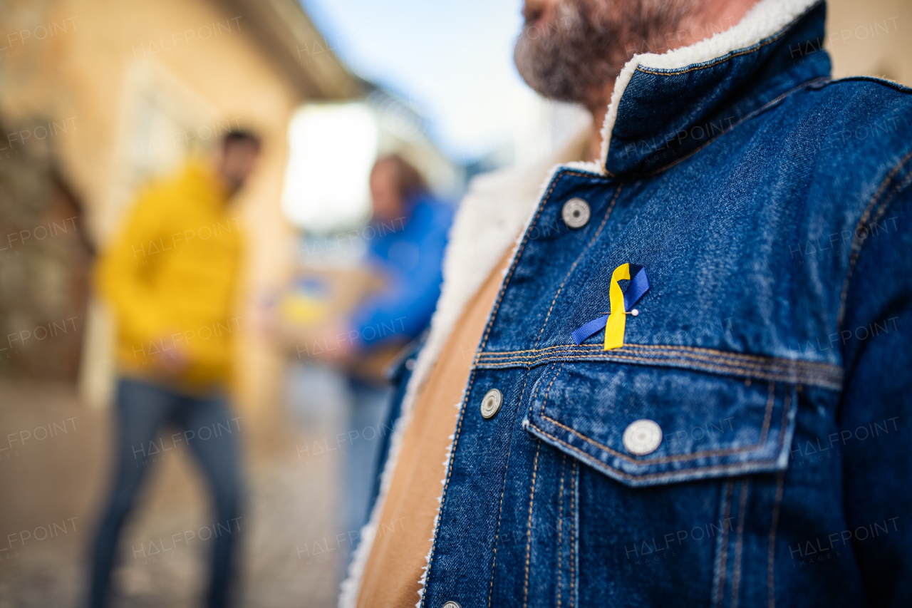 The protestors with Ukrainian blue and yellow ribbons protesting against war in Ukraine in street