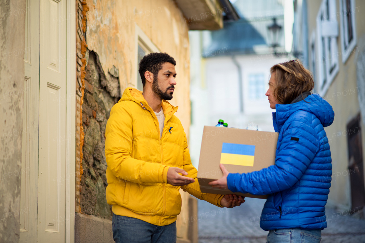 Volunteers collecting boxes with Humanitarian aid for the Ukrainian refugees in street