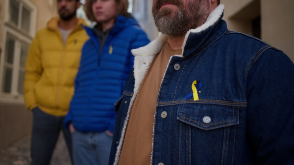 Protestors with Ukrainian blue and yellow ribbons and flags protesting against a war in Ukraine in street