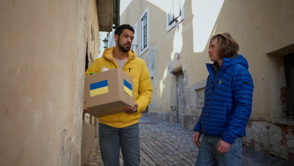 Volunteers collecting boxes with Humanitarian aid for the Ukrainian refugees in street