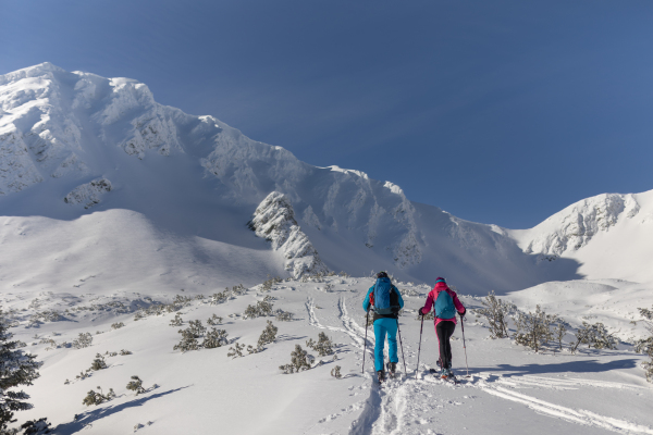 A ski touring couple hiking up a mountain in the Low Tatras in Slovakia.