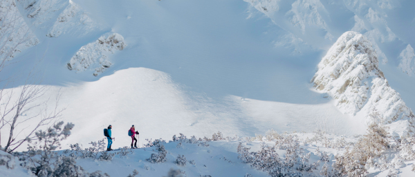 A front view of ski touring couple hiking up in the Low Tatras in Slovakia.