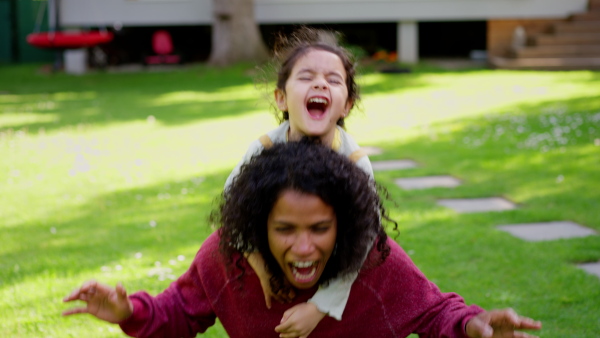 A mother and daughter having fun, spending time outdoor in nature during summer