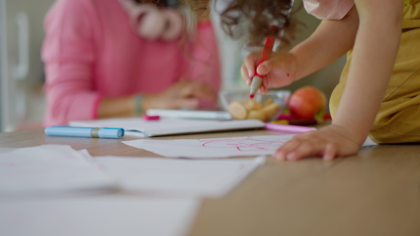 A Mother working from home while child is drawing picture. Home office concept.