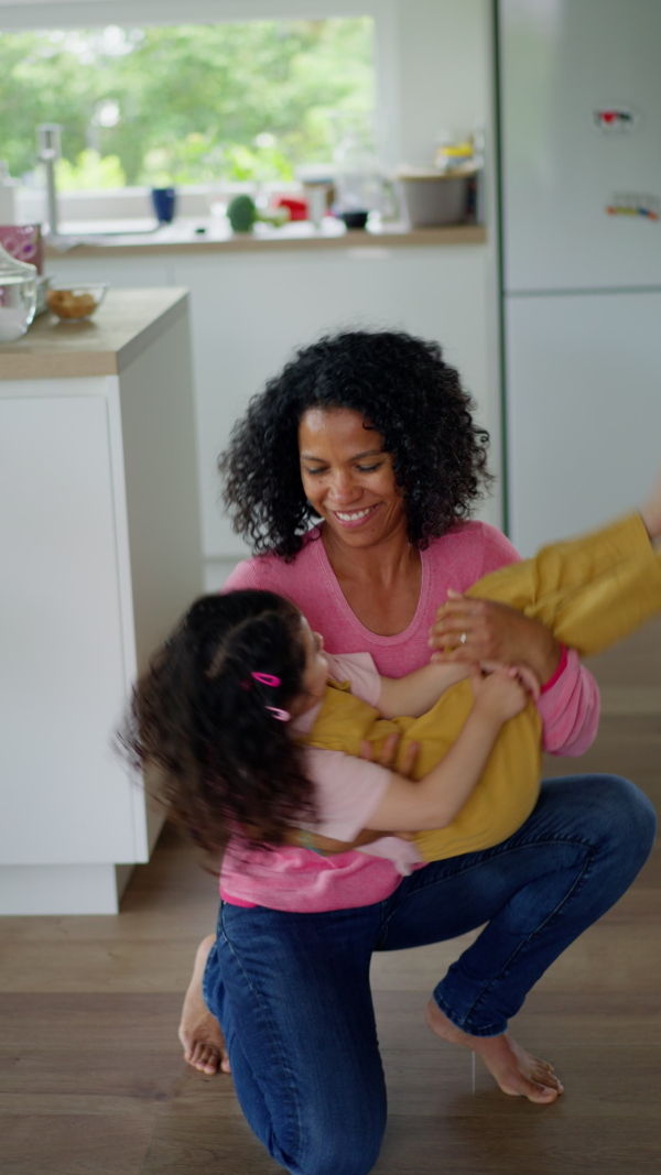 A mother and daughter having fun, spending time together at home.