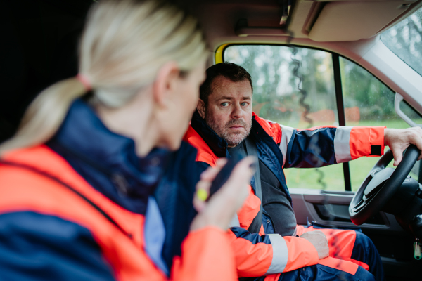 Team of rescuers preparing in an ambulance car to outdoor operation.