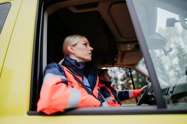 Portrait of young woman doctor sitting in the ambulance car.