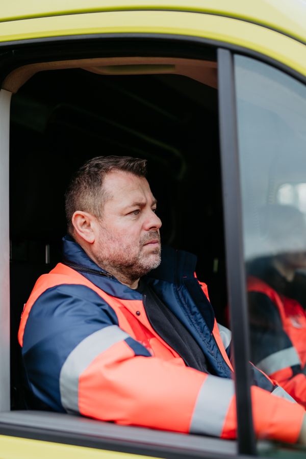 Portrait of rescuer sitting in the ambulance car.