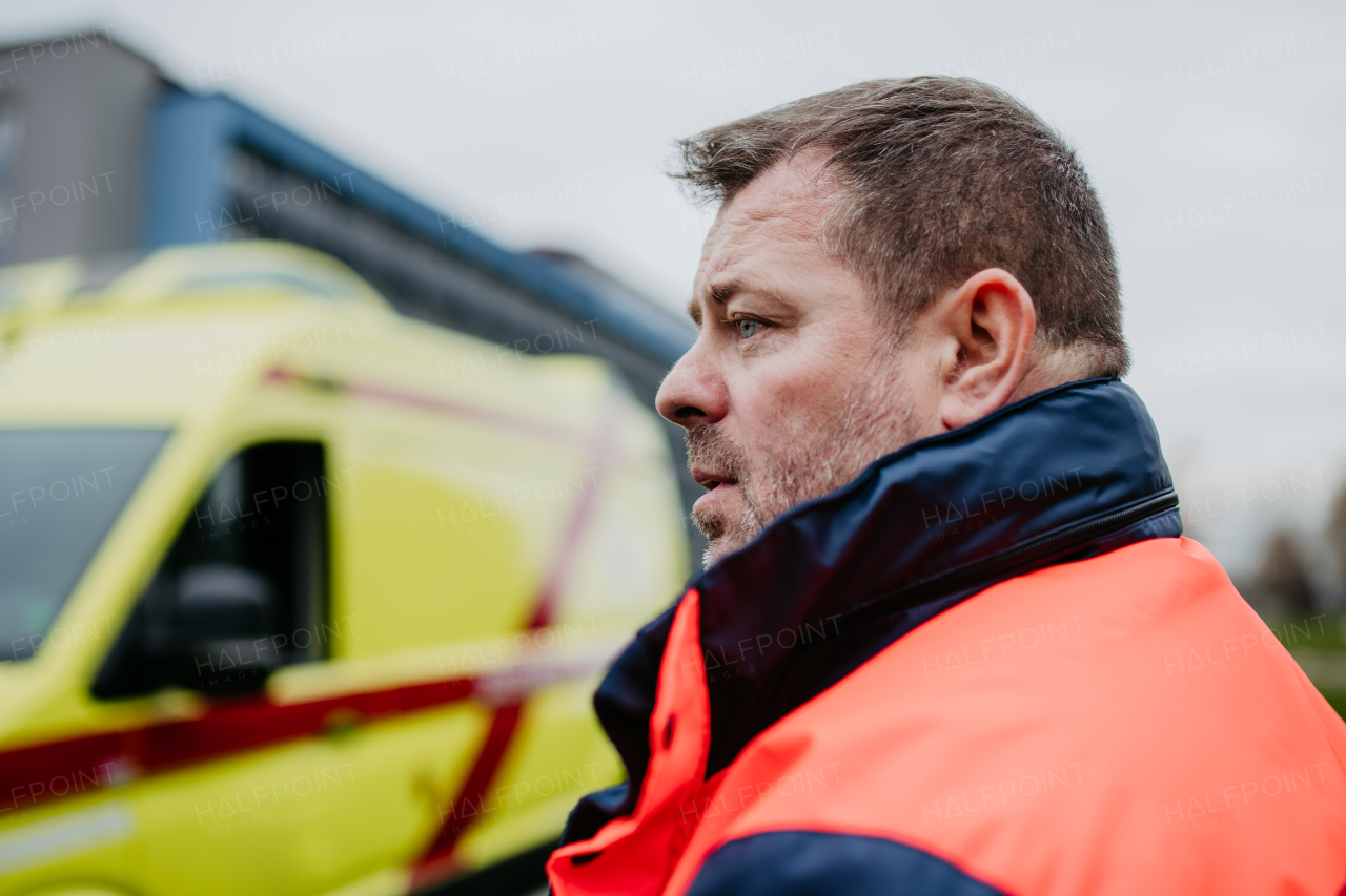 Portrait of rescuer standing near of the ambulance car.