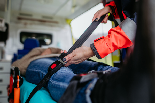 Rescuer taking care of a patient, preparing her for transport.