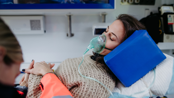 Rescuer taking care of a patient, preparing her for transport.