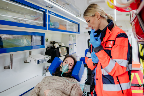 Rescuer taking care of a patient, preparing her for transport.