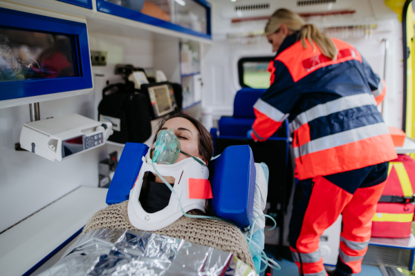 Rescuer taking care of a patient, preparing her for transport.