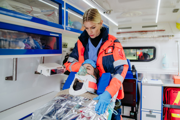 Rescuer taking care of a patient, preparing her for transport.