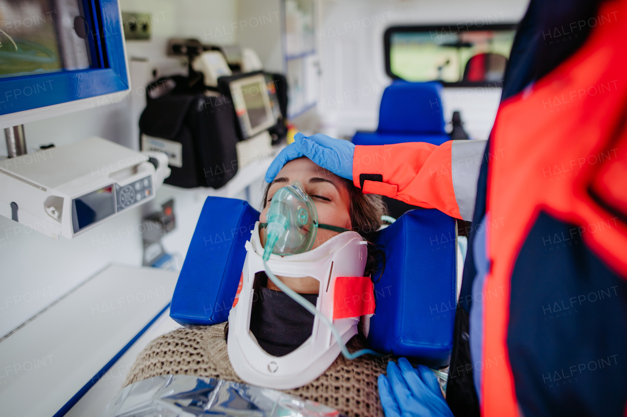 Rescuer taking care of a patient, preparing her for transport.