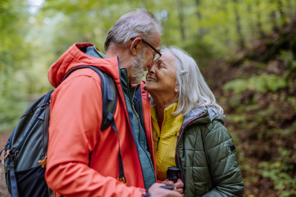 Senior couple in love huging each other in autumn forest.