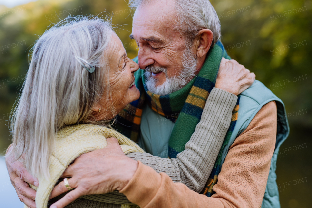 Senior couple in love huging each other in autumn forest.