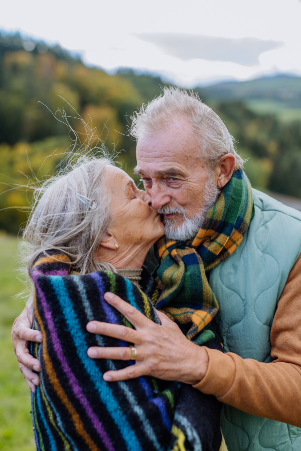 Senior couple in love huging each other in autumn forest.