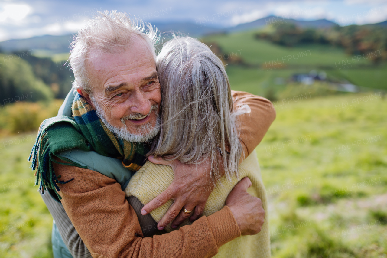 Senior couple in love huging each other in autumn forest.