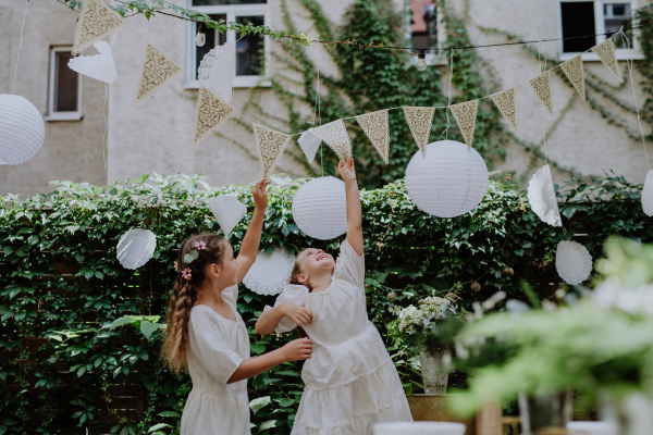 Little girl having fun at an outdoor wedding party.