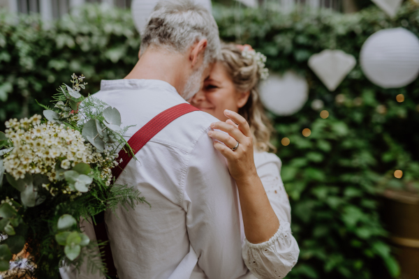 Close-up of bride and groom dancing at their outdoor wedding.