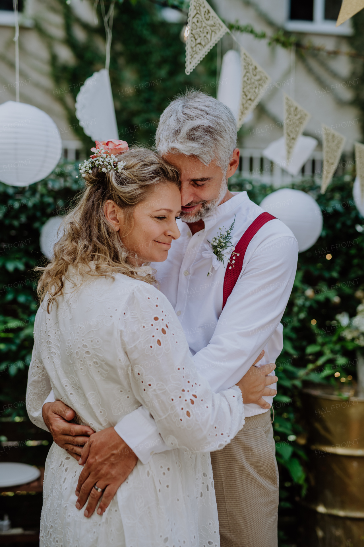 Close-up of bride and groom dancing at their outdoor wedding.