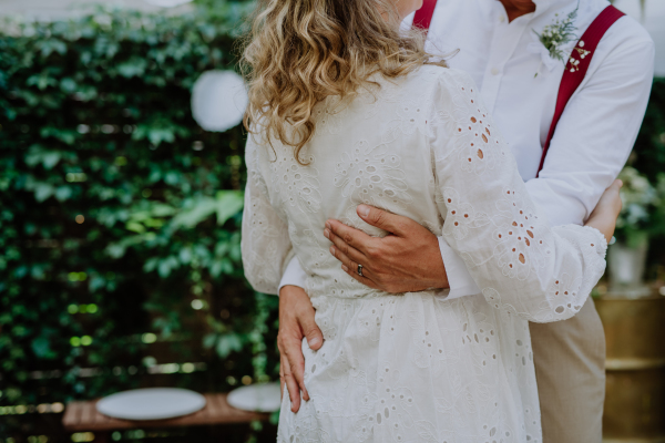 Close-up of bride and groom dancing at their outdoor wedding.